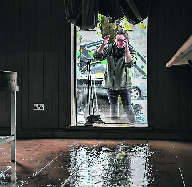 Sally O’Brien surveys the damage to the Farmgate Cafe in Midleton caused by Storm Babet in October 2023.	Picture: Chani Anderson
                    