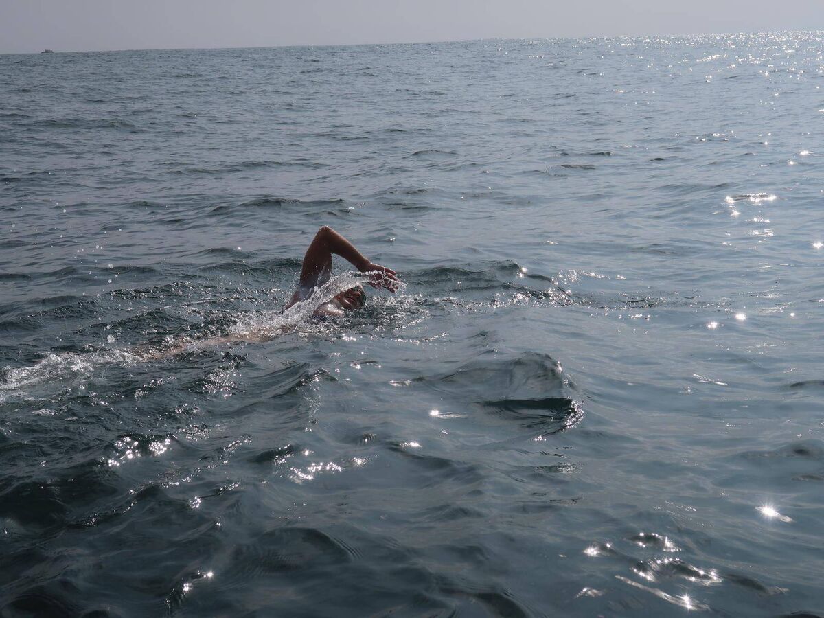 Olga O’Sullivan swimming into the sun.