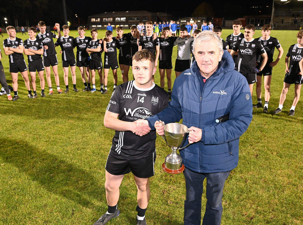 Michael O'Mahony, chairman Rebel Óg presents the trophy to Donoughmore captain Redmond Reardon after defeating Castlehaven in the Rebel Óg Premier 2 MFC final at Pairc Ui Rinn. Picture: Eddie O'Hare