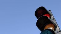 Close-up of traffic lights against blue sky