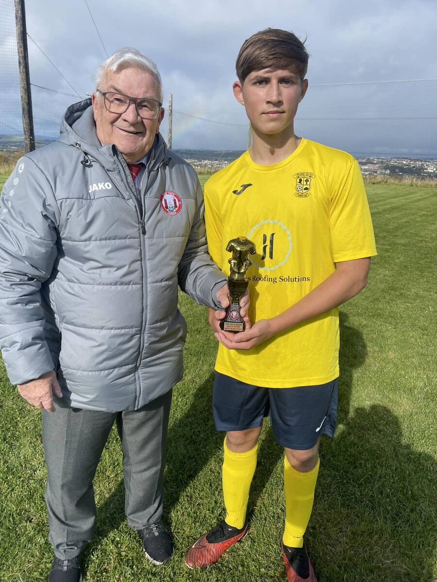 Christy Byrne from the Cork Youth League presents the Gary McCarthy Trophies Man of the Match award to Pearse Celtic’s Ryan Cremin.