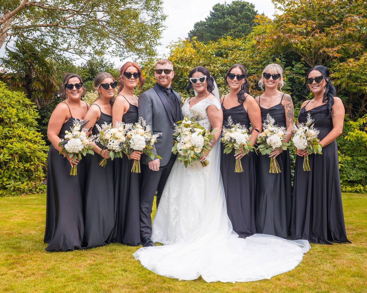 The bride and groom with the bridal party, made up of family and close friends.