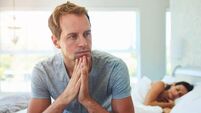 Man, thinking and married in bedroom at house with stress, anxiety and problem of secret from cheating on sleeping woman. Frustr