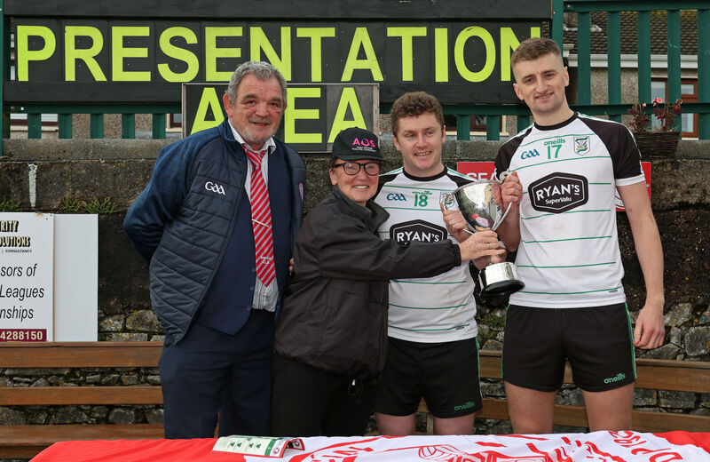 Mick Buckley and Jess O'Sullivan, AOS Security, present David Sheahan and Conor O'Donoghue, Douglas joint-captains, with the cup. Picture: Jim Coughlan. Mick Buckley and Jess O'Sullivan, AOS Security, present David Sheahan and Conor O'Donoghue, Douglas joint-captains, with the cup. Picture: Jim Coughlan.