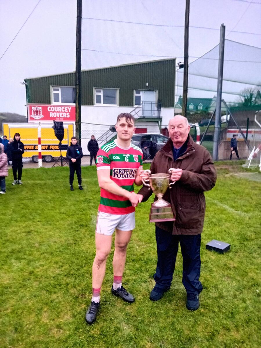 Rory Sinclair accepting the Con Murphy trophy from Carrigdhoun chairman Myles Barry after Tracton beat Valley Rovers. Rory Sinclair accepting the Con Murphy trophy from Carrigdhoun chairman Myles Barry after Tracton beat Valley Rovers.