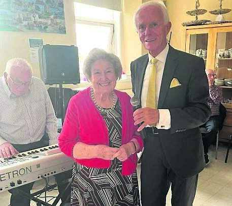 Mary Conway entertaining the residents at St Finbarr’s Hospital, Douglas, with Paddy O’Brien and Ger Bruton on keyboards.
