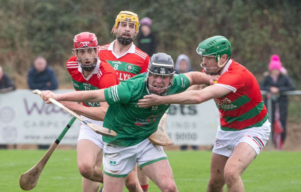  Killeagh's Sean Meade attempts to break away from Carraig na bhFear's John Forde, Mike Ahern and Jack Ahern. Picture: Howard Crowdy