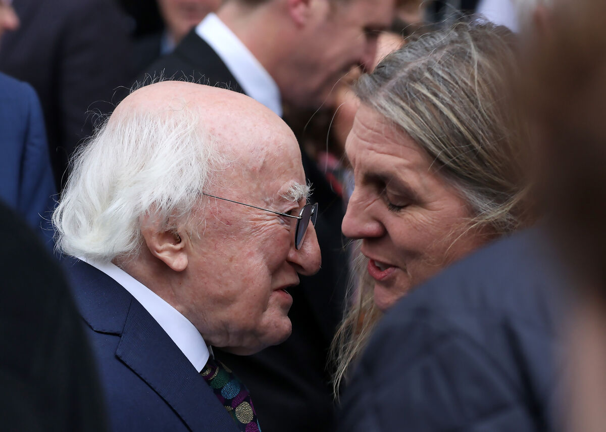 President Michael D Higgins consoles David Davin Power's wife Dearbhla.