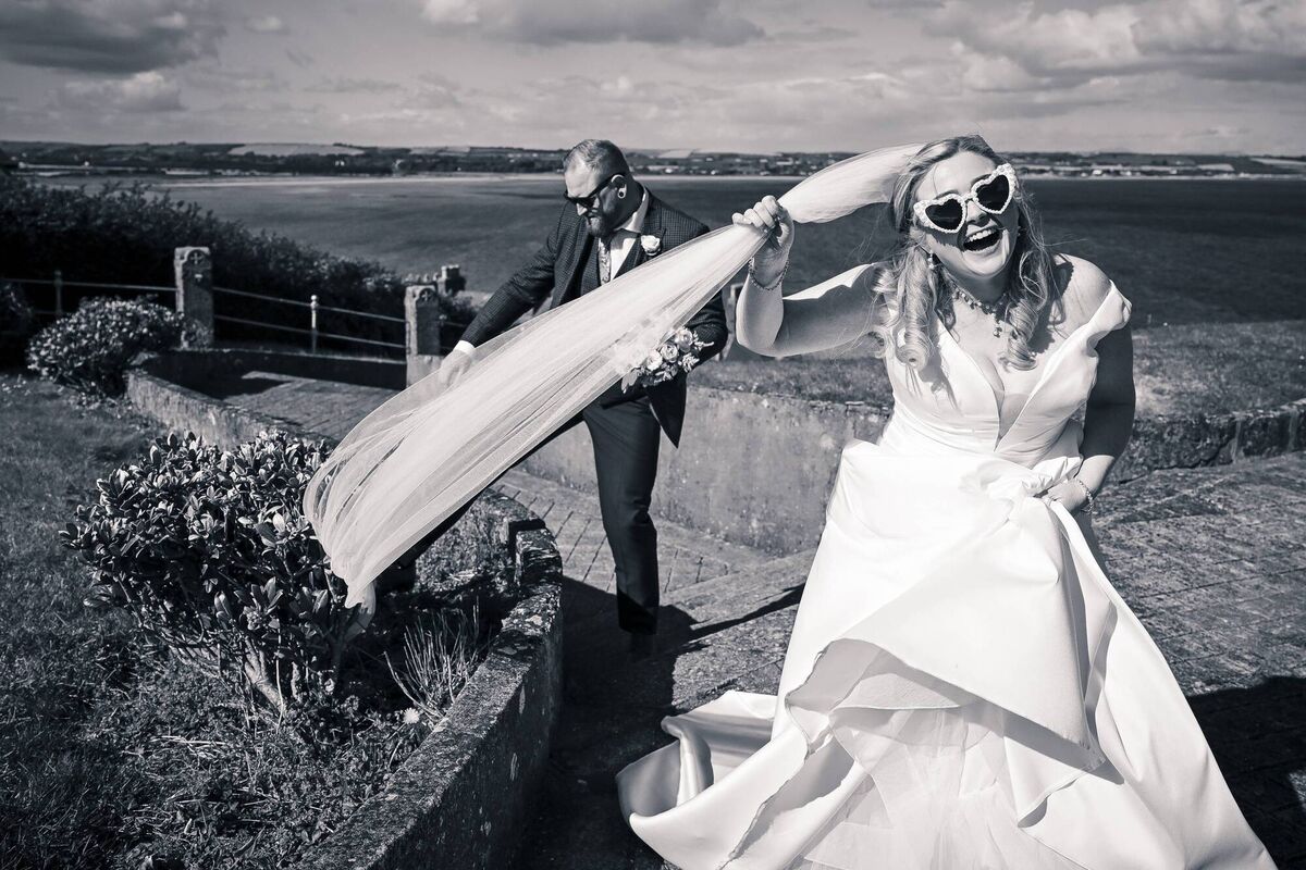 The bride and groom having some fun on their wedding day, with photographer John Sexton.