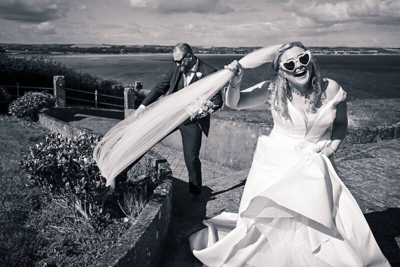 The bride and groom having some fun on their wedding day, with photographer John Sexton. The bride and groom having some fun on their wedding day, with photographer John Sexton.