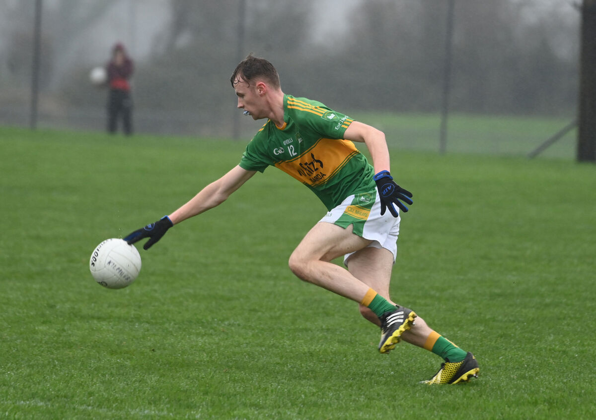 Kilmurry's Rory Duggan in action in the wet conditions against Michael Cusack's in Cloughduv. Picture: Larry Cummins