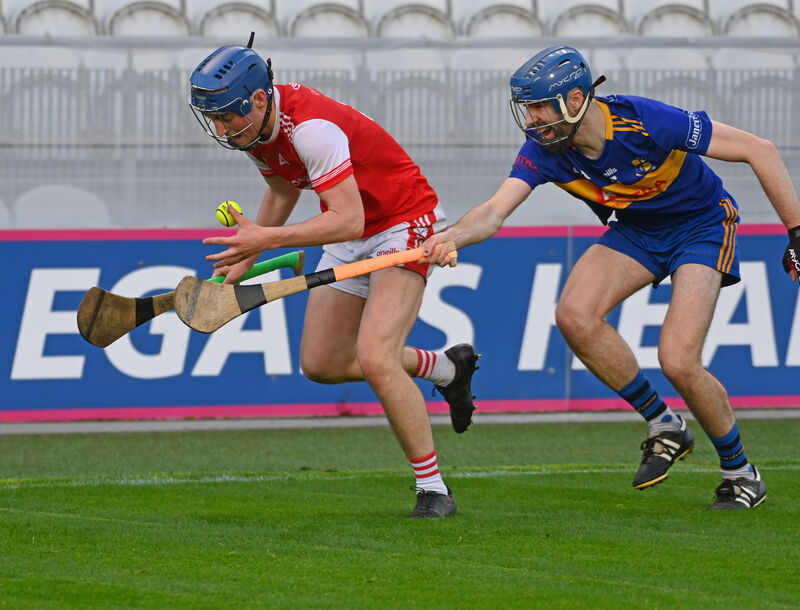 Watergrasshill's Dylan Roche gathers the sliothar despite the attentions of Carrigaline's Brian Kelleher. Picture: Eddie O'Hare