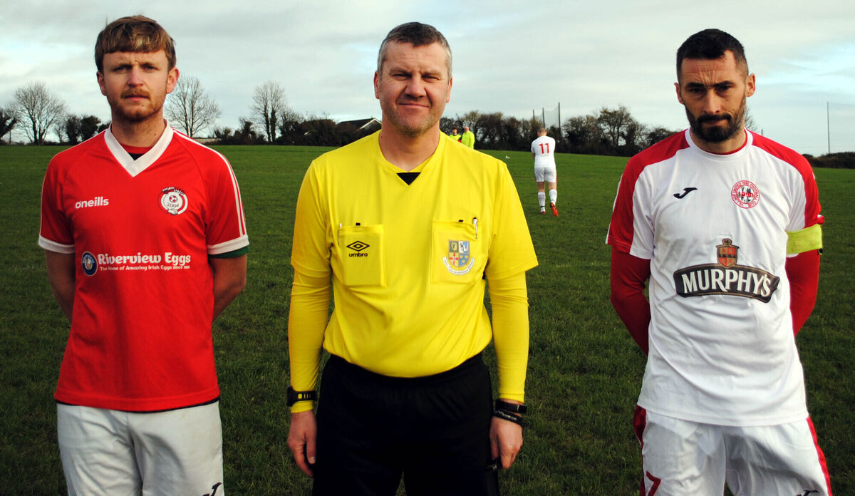 Village United's captain Colin Hickey (right) with Watergrasshill United's Brendan Maloney, accompanied by referee Vlastimir Albert. Village United's captain Colin Hickey (right) with Watergrasshill United's Brendan Maloney, accompanied by referee Vlastimir Albert.
