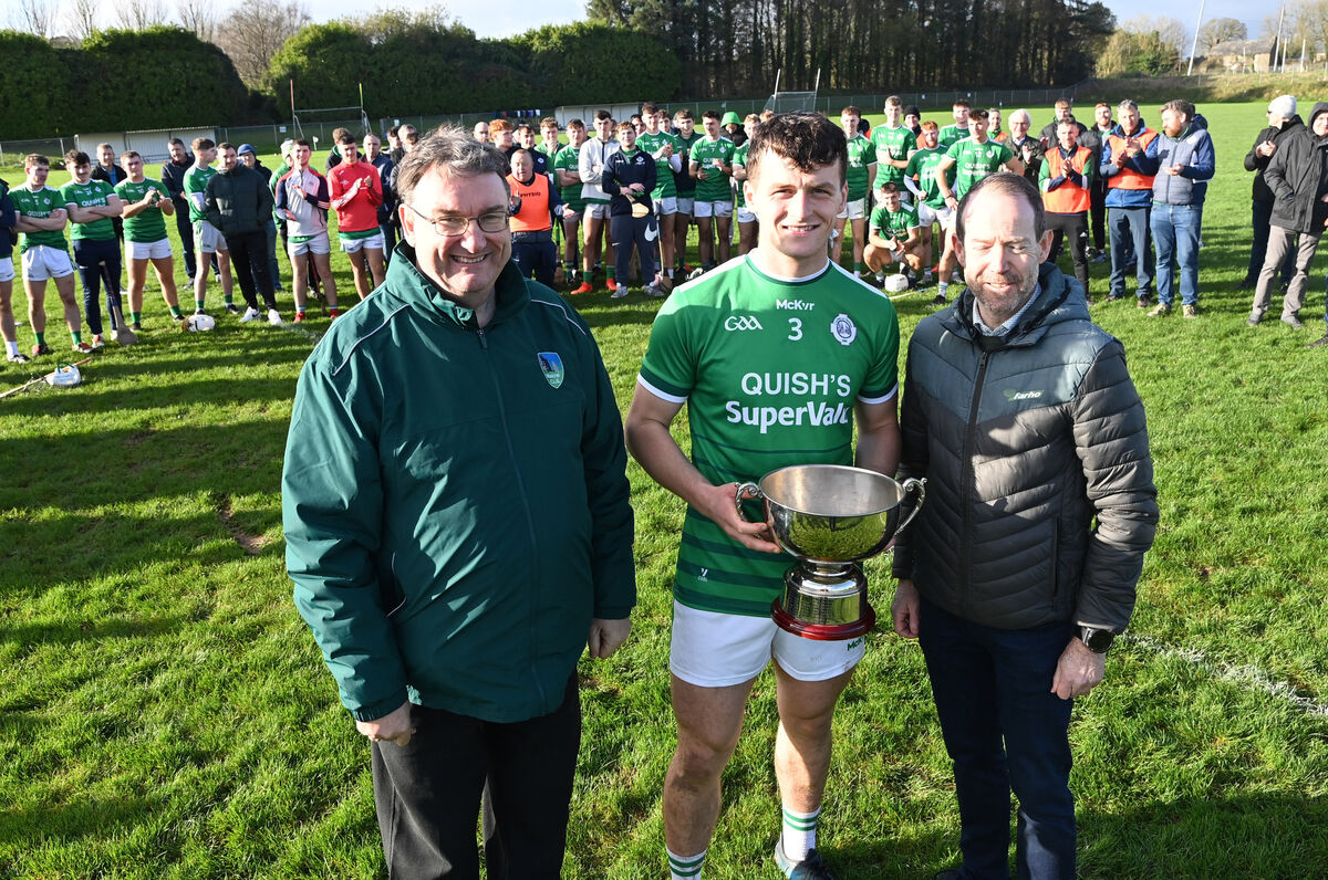 John Feeney, chairman Muskerry, and Derry Casey of Farho present the trophy to Ballincollig captain David O'Sullivan. Picture: Eddie O'Hare