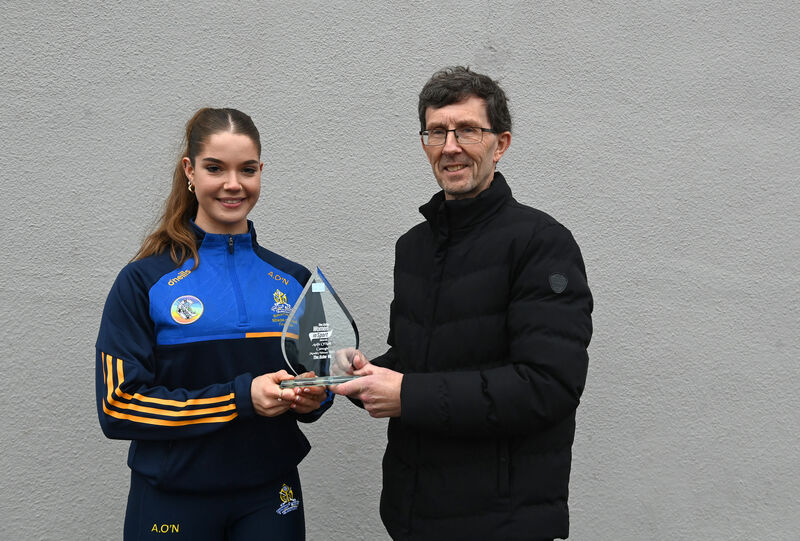 The Echo Women in Sport winner Aoife O'Neill, St Finbarr's, is presented with her trophy by Rory Noonan of The Echo. Picture: Larry Cummins