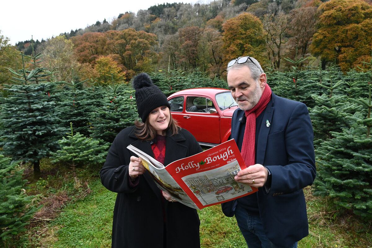 Mary Corcoran, Editor, Holly Bough with artist Peter Buckley who is this year's cover art creator, with his red Volkswagen VW Beetle car which is featured in the artwork, pictured at Inniscarra Christmas Tree Farm. Pic Larry Cummins