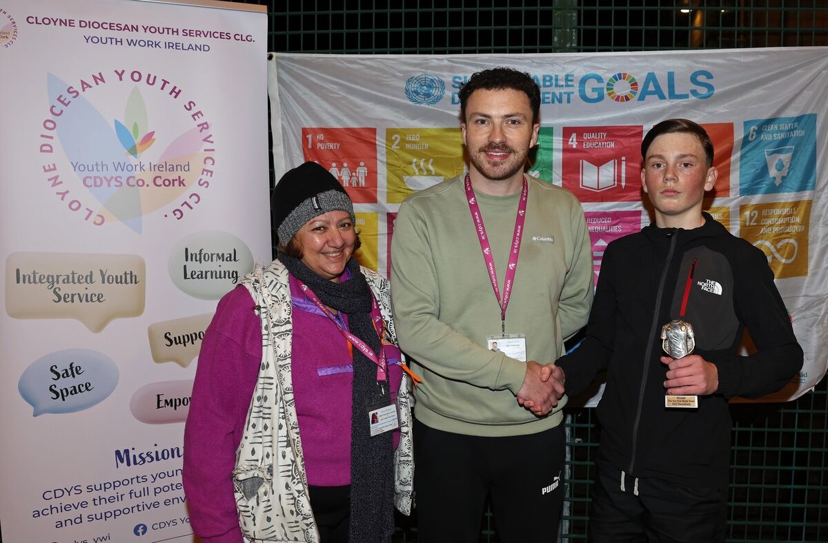 Nadia Moussed, Global Youth Work coordinator CDYS, and Joe Curtin, youth worker CDYS, present Tony Casey with his winning team trophy, during The Hut One World Week Sustainable Development Goals (SDG) Football Tournament, at the Sam Allen Sports Complex, Churchfield.