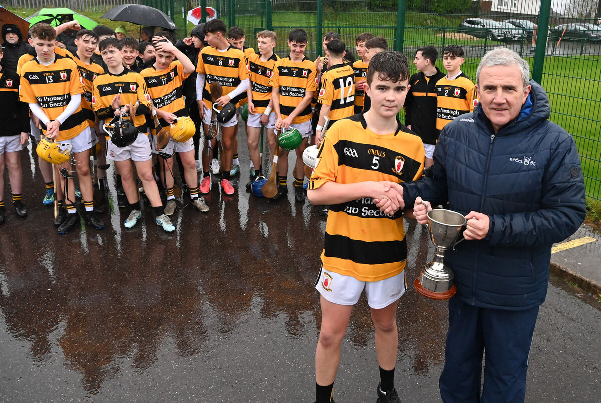 Michael O'Mahony, chairman Rebel Óg, presents the trophy Na Piarsaigh captain Darragh Casey. Picture: Eddie O'Hare
