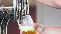 Barmans arms pulling a pint of beer