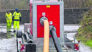<p class="contextmenu internal_Caption">Cork County Council workmen pumping away flood water in Skibbereen at the weekend. Picture: Andy Gibson</p>