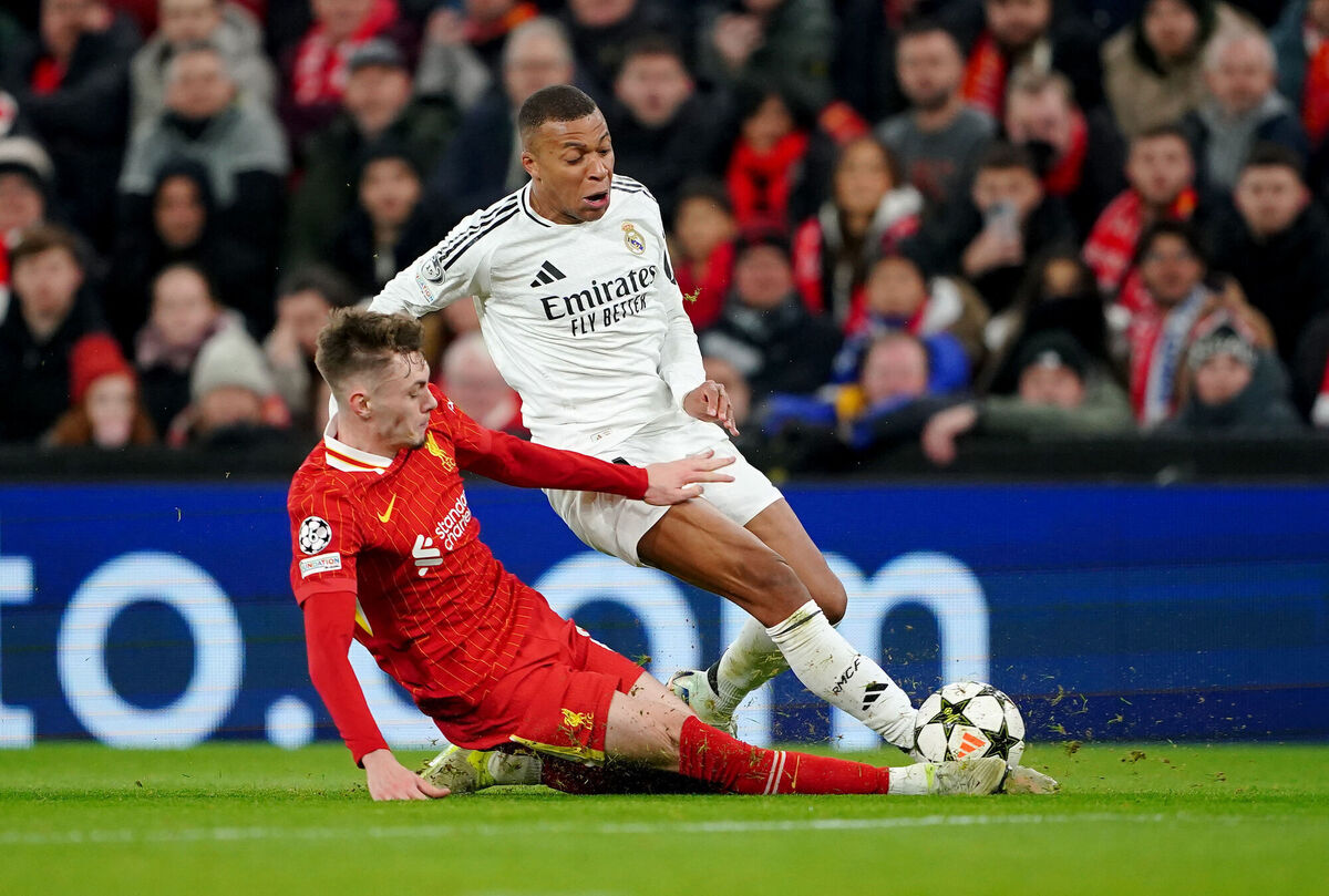 Liverpool's Conor Bradley clears out Real Madrid's Kylian Mbappe in the tackle during their UEFA Champions League match at Anfield, Liverpool, on Wednesday. Picture: Peter Byrne/PA Wire