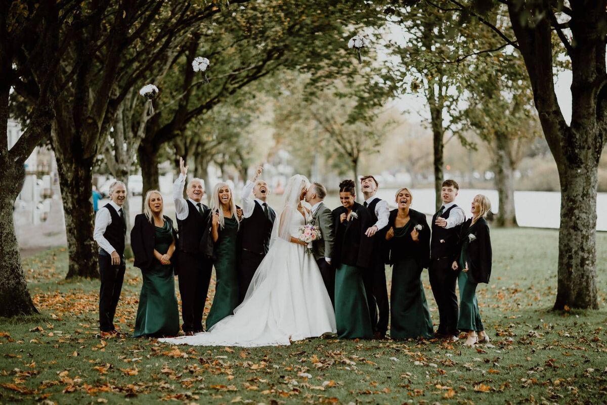 Barbara and Garrett pictured with their bridal party on their wedding day.