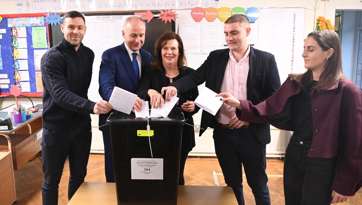 Micheál Martin, Tánaiste and leader of Fianna Fáil voting with wife Mary and children Micheál Aodh, Cillian and Aoibhe at St Anthony's BNS, Ballinlough Cork for the general election 2024. Picture: Larry Cummins