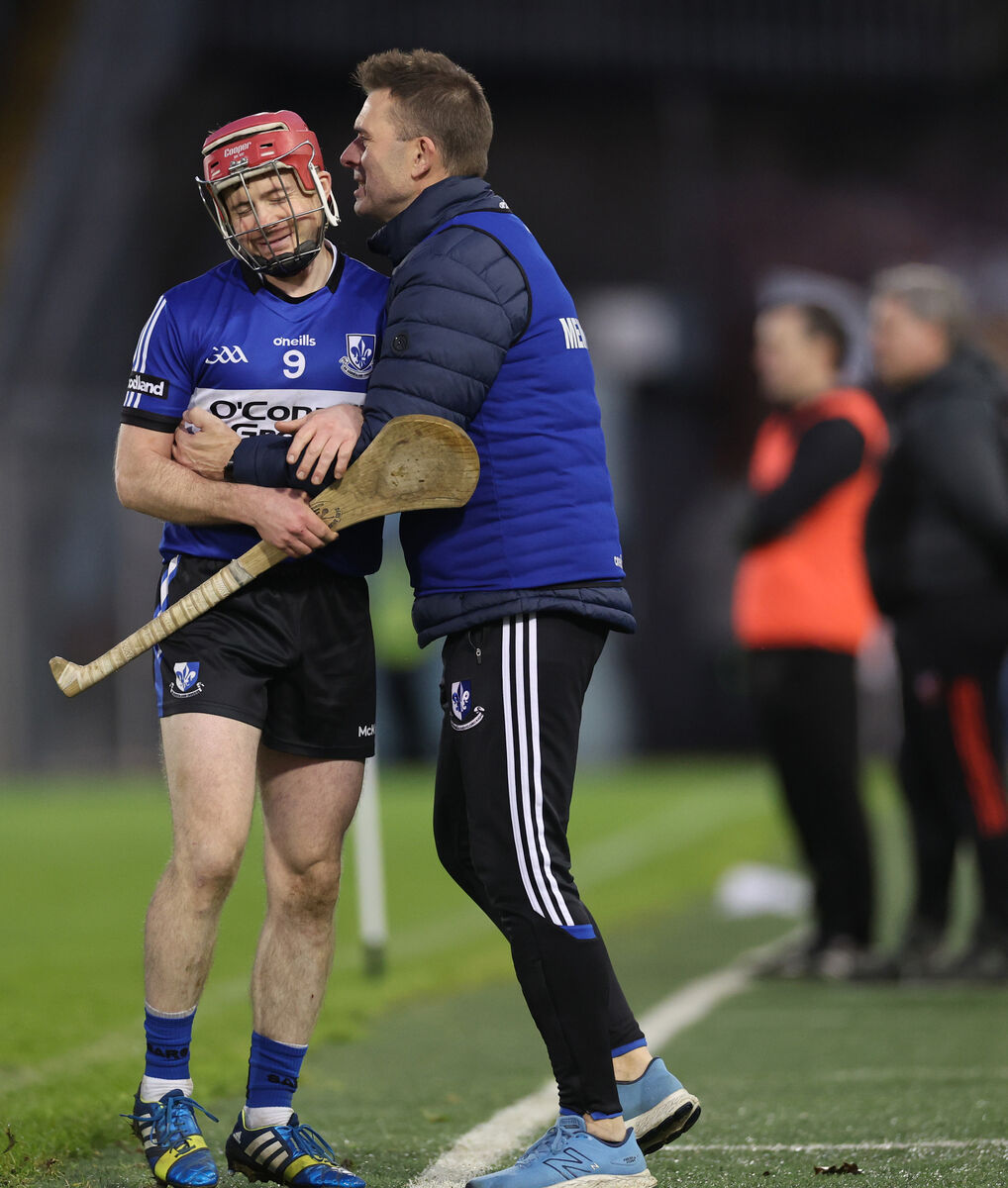 Sarsfields’ Daniel Kearney and manager Johnny Crowley celebrate late in the game. Picture: INPHO/James Crombie