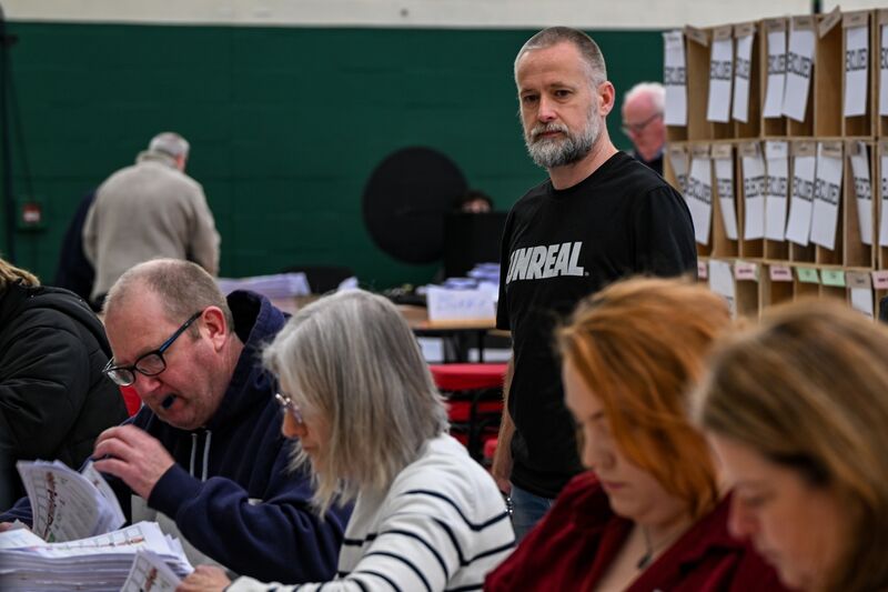 Count staff Cian O’Connor wears an ‘unreal’ t-shirt as the recounting begins in Nemo after just 35 votes separated Labour’s Eoghan Kenny and People before people profit solidarity’s Mick Barry in the final count. Picture: Chani Anderson.