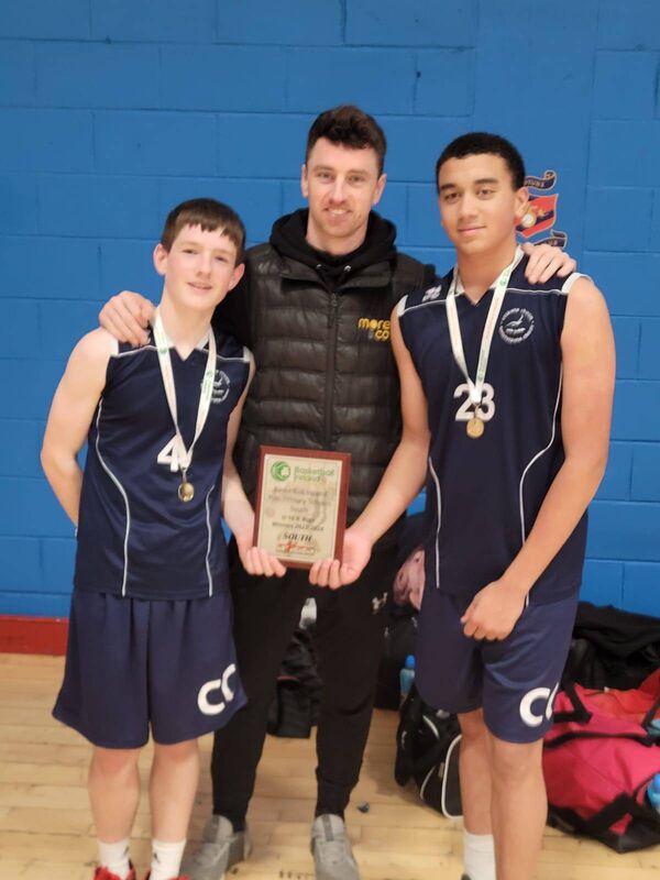 Cork Basketball: Coláiste Choilm U16 captains Daithí Murphy and Ellis James with Irish international and past pupil Adrian O'Sullivan after winning the Basketball Ireland PPS South U16 A final at Neptune Stadium.