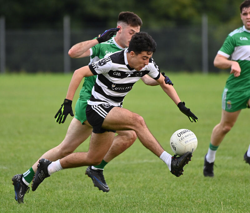 Castletownbere's Jonathan Rosales Harrington on the ball from Macroom's Eolan O'Leary. Picture: Eddie O'Hare