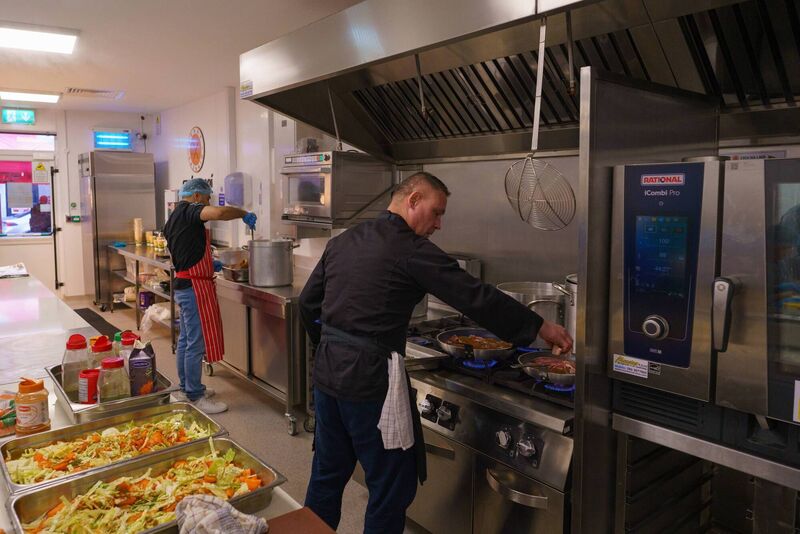 Volunteers cooking food and prepping meals in the new kitchen facilities at Croí na Laoí, part of Cork Penny Dinners new facilities on James Street.