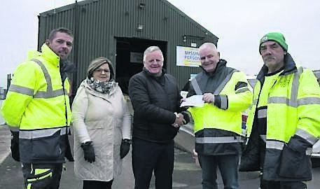 Fr Michael O’Leary and Pauline Neff visiting the Cork City Missing Persons Search and Recovery base to present a cheque to volunteers Chris O’Donovan, Dinny Kiely, and Dave Varian.
                        Picture: Cork City Missing Persons Search and Recovery
                    