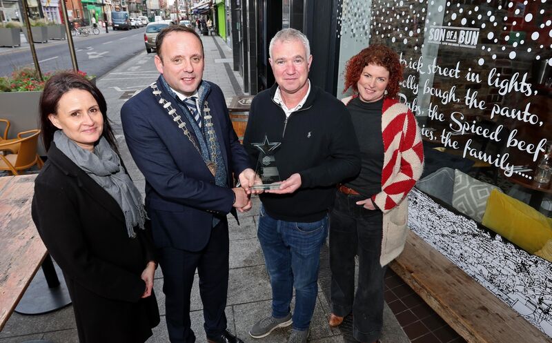 Aaron Mansworth presents the Best Non-Retail Display award to Niall O’Regan, Son of A Bun, MacCurtain St, along with Cliona Barnes and Lisa McCarthy. The restaurant was said to have delivered a display that was ‘creative and engaging’ with ‘wonderful messaging and beautiful illustration’. Picture: Jim Coughlan. Aaron Mansworth presents the Best Non-Retail Display award to Niall O’Regan, Son of A Bun, MacCurtain St, along with Cliona Barnes and Lisa McCarthy. The restaurant was said to have delivered a display that was ‘creative and engaging’ with ‘wonderful messaging and beautiful illustration’. Picture: Jim Coughlan.