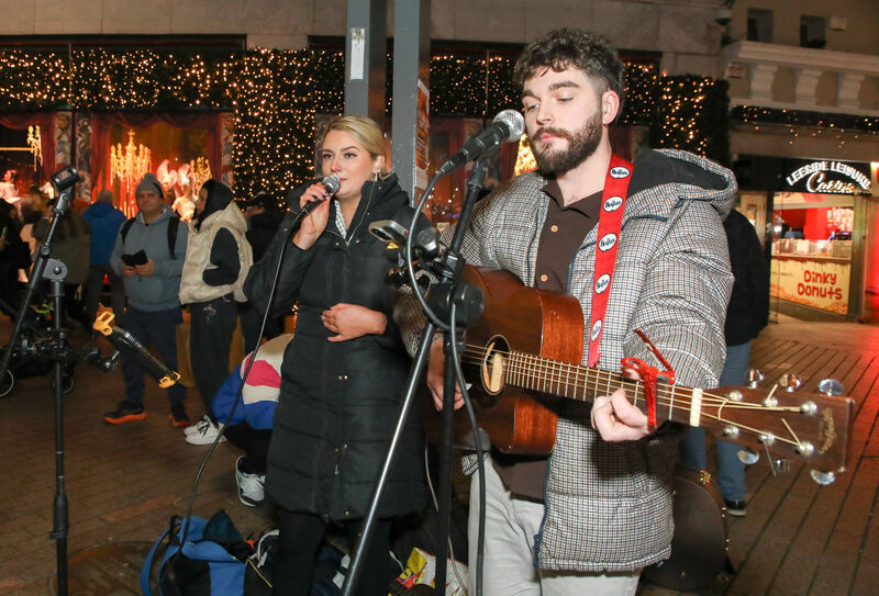 Nichole Desmond and William O'Halloran perform during the annual busking marathon to raise funds for Penny Dinners on Patrick Street, Cork.  Pictures: David Creedon.