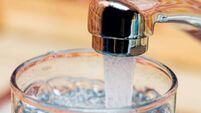 Filling up a glass with drinking water from kitchen tap