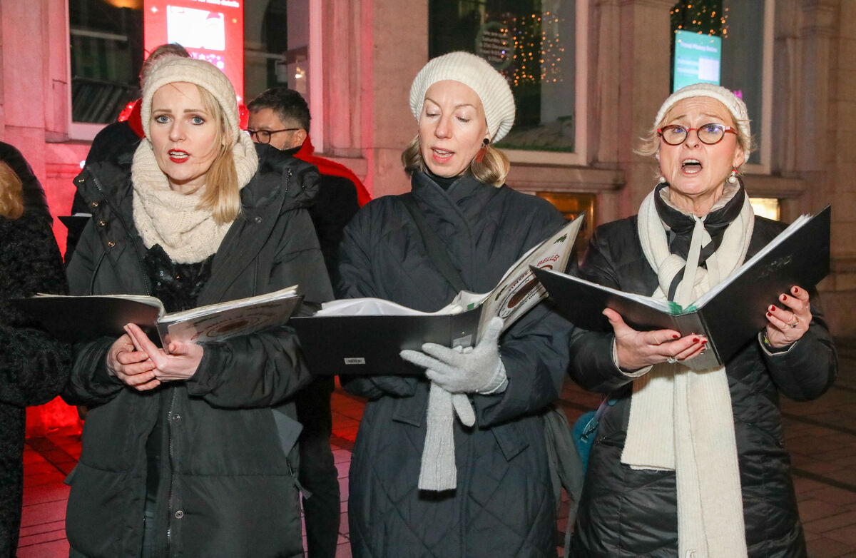  Members of the Jingle Belles Choir sing to raise funds for Penny Dinners on Oliver Plunkett Street, Cork. - Picture: David Creedon