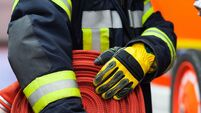 Firefighter wearing a rolled hose