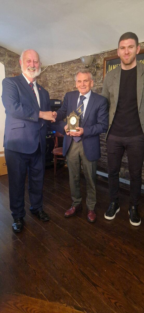 Sean O'Sullivan, presents Carrigaline United's Willie Walsh with a Services to Football award. Also included is Luke Connolly, Heineken Ireland.