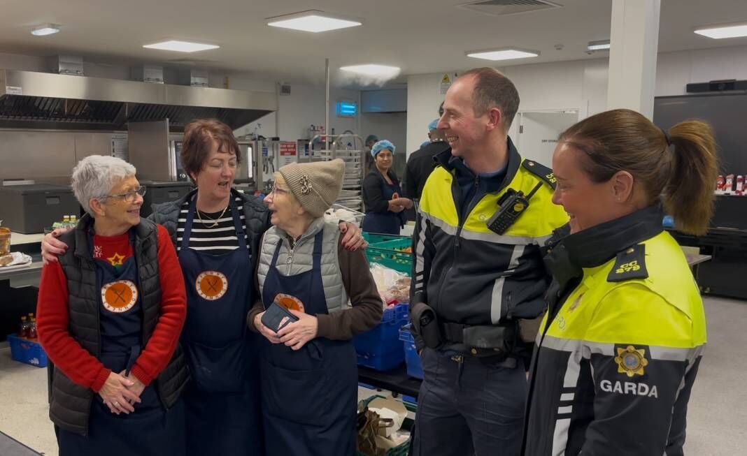 Cork Penny Dinners volunteers Olive Morris, Eilish Kearney and Patsy McCarthy serenade community gardaí Damien Desmond and Karen Ring with a chorus of 'Please Release Me'. Picture: Donal O'Keeffe