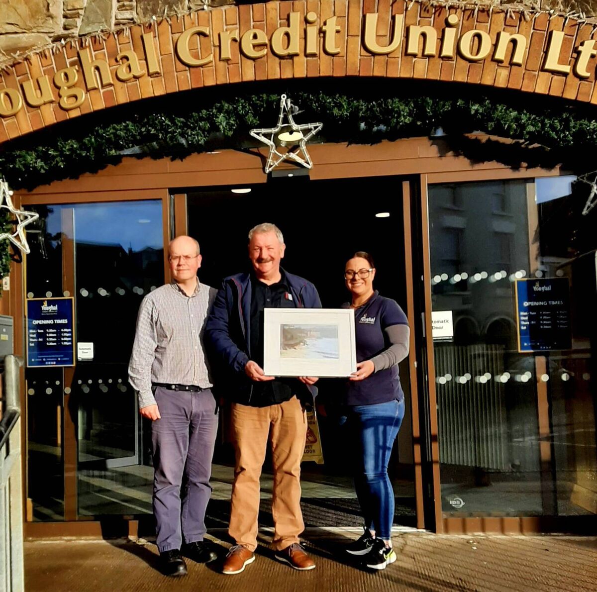 William Walsh with a print of one of his pictures which was selected by Youghal Credit Union.