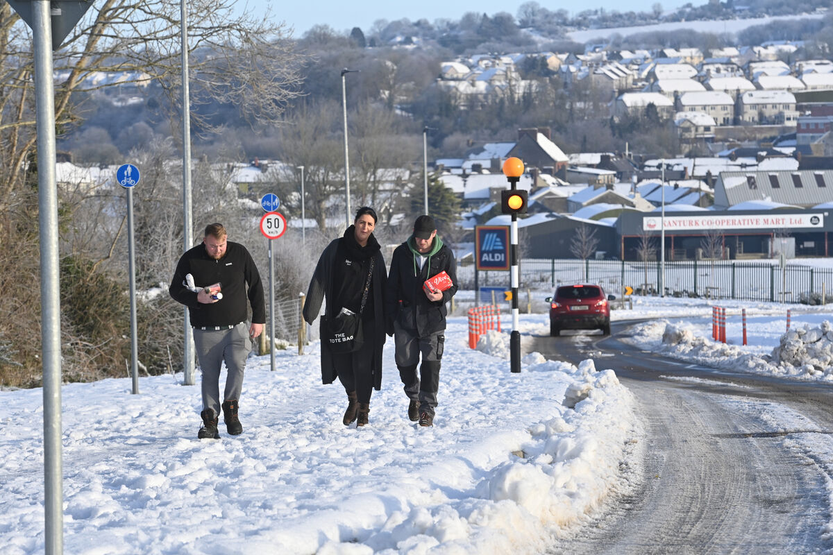  Making their way home in the snow from the shops were Jamie O'Keffe, Claire Murphy and Barry O'Leary in Kanturk, Co Cork. Picture Dan Linehan