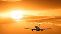 Plane is taking off at sunset