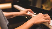 Asian woman hand playing keyboard of a piano in romantic atmosphere. Music instrument, solo pianist, song composer, hobby, pract