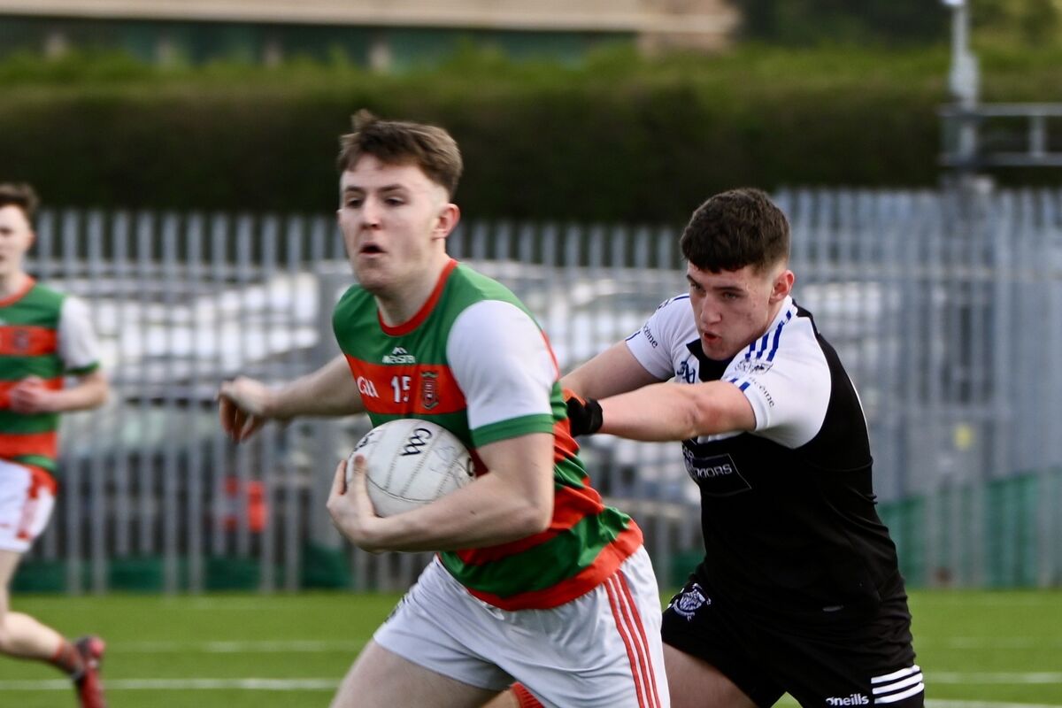 Mallow’s Cathal Corbett is held back during the Corn Uí Mhuirí quarter final clash between Patrician Academy Mallow and Kenmare in Bishopstown on Wednesday. picture Chani Anderson