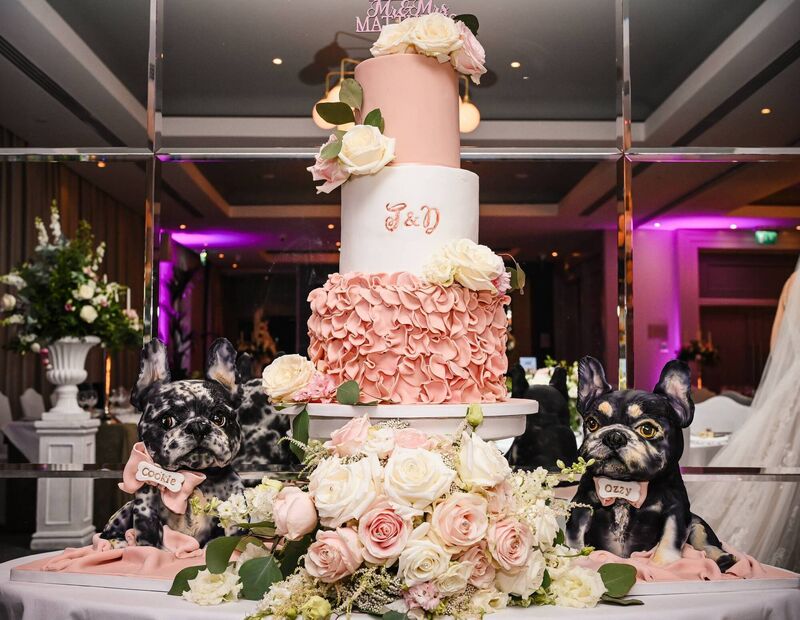 The couple’s cake was by Trace of Cakes and even featured recreations of their two dogs. The couple’s cake was by Trace of Cakes and even featured recreations of their two dogs.