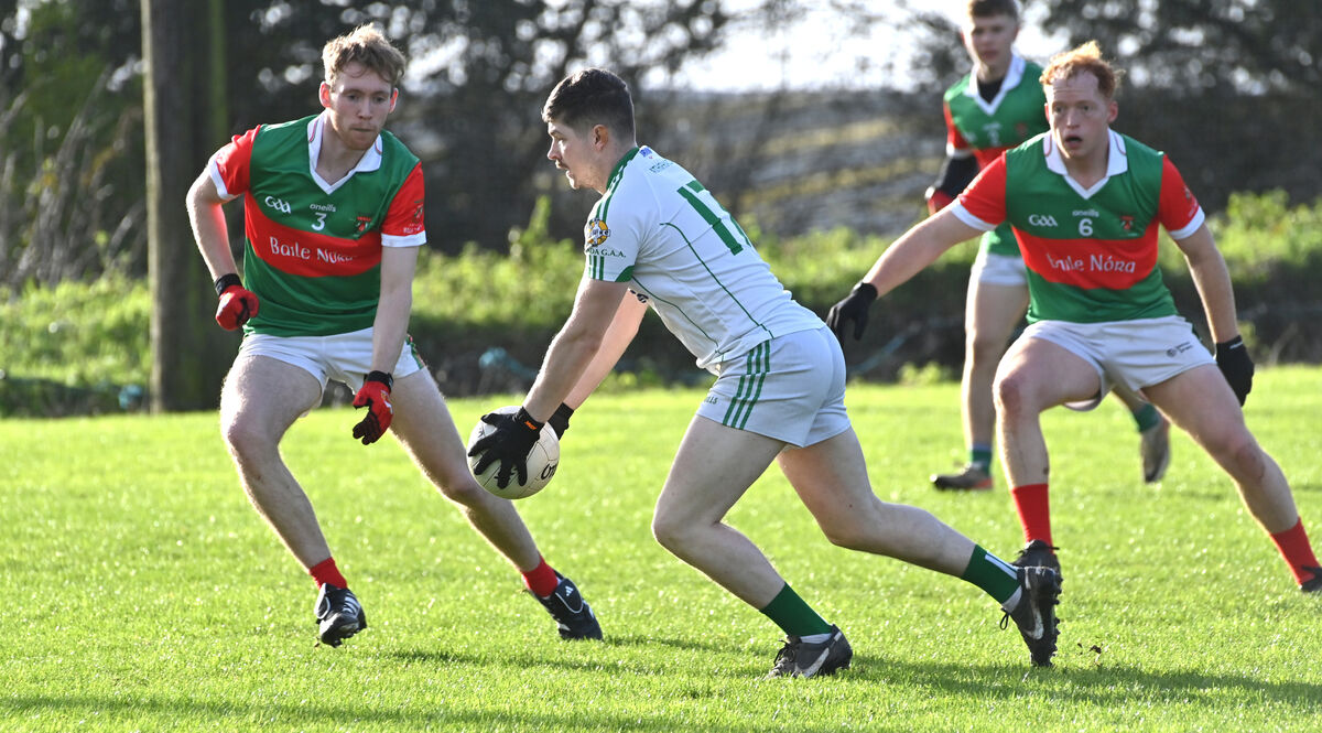  Ballinora players Adam Laverty and Colin O'Flynn looking to stop the run of Fintan Cody, Aghada, during their McCarthy Insurance U21 A football championship at Caherlag. Picture: Dan Linehan