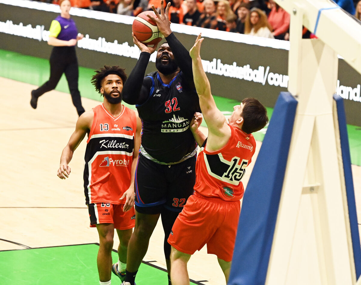 UCC Demons' Elijah Tillman lays up a basket from Killester's Isiah Dasher and Ciaran Roe during the Pat Duffy national cup final at the National Basketball Arena, Tallaght. Picture: Eddie O'Hare