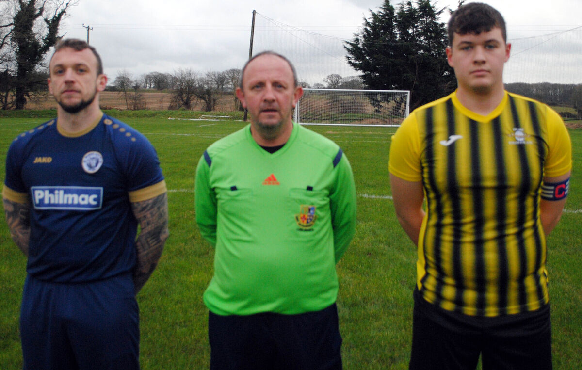 Strand B's captain Dylan Quinn (right) with Belmount Celtic's Patrick O'Sullivan, accompanied by referee Paul Bowdren.