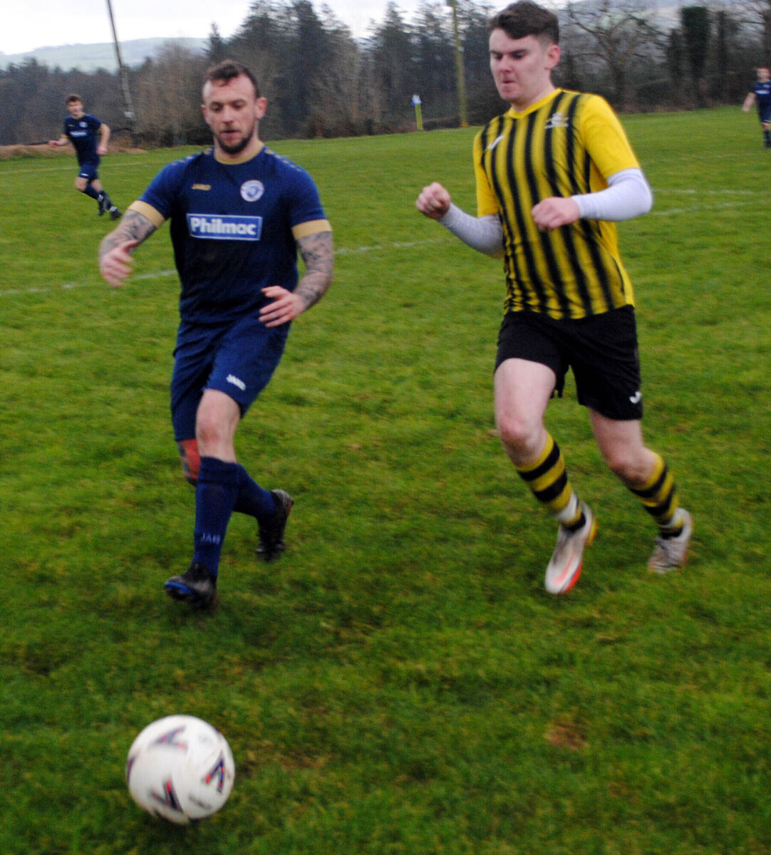 Strand B's Joseph Donovan and Belmount Celtic's Patrick O'Sullivan in a race for possession.